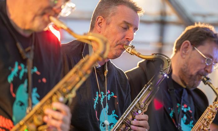 Close up of 3 men playing saxophones at the Swansea Jazz Festival